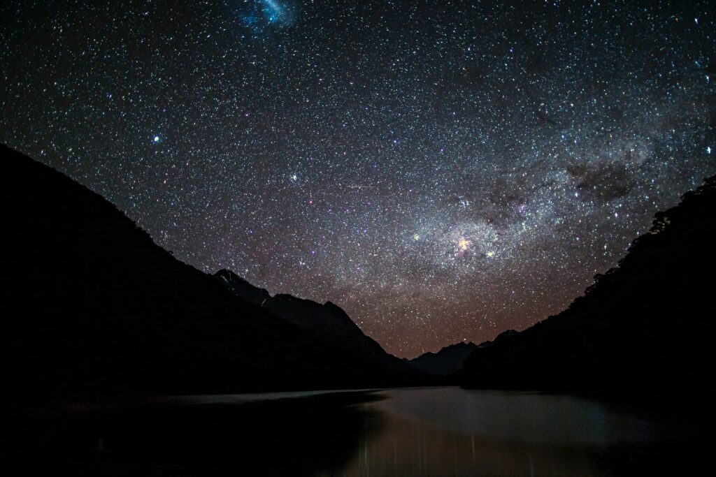 Stunning Starry Night Wallpaper: Serene Mountains & Reflective Waters