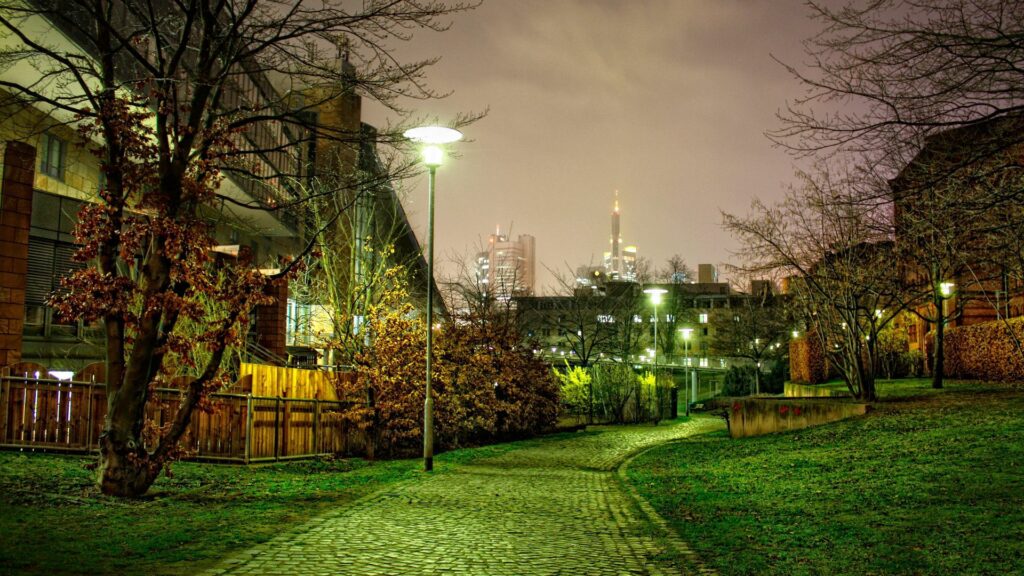 Enchanting Night Street Wallpaper: Cobblestone Park and Warm Lights