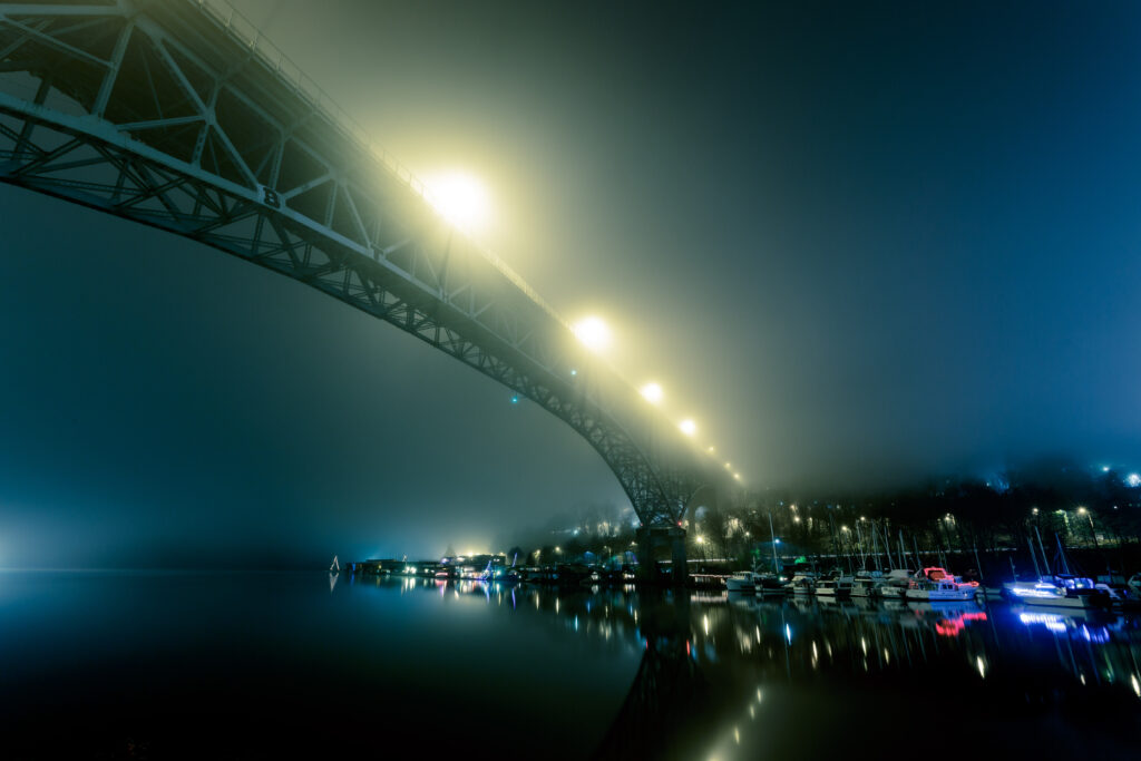Serene Night Wallpaper: Foggy Bridge & Soft Lights Reflection