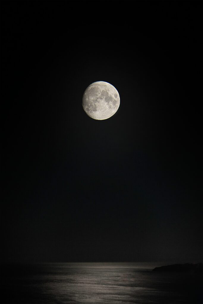 Serene Night Wallpaper: Luminous Full Moon Over Calm Sea