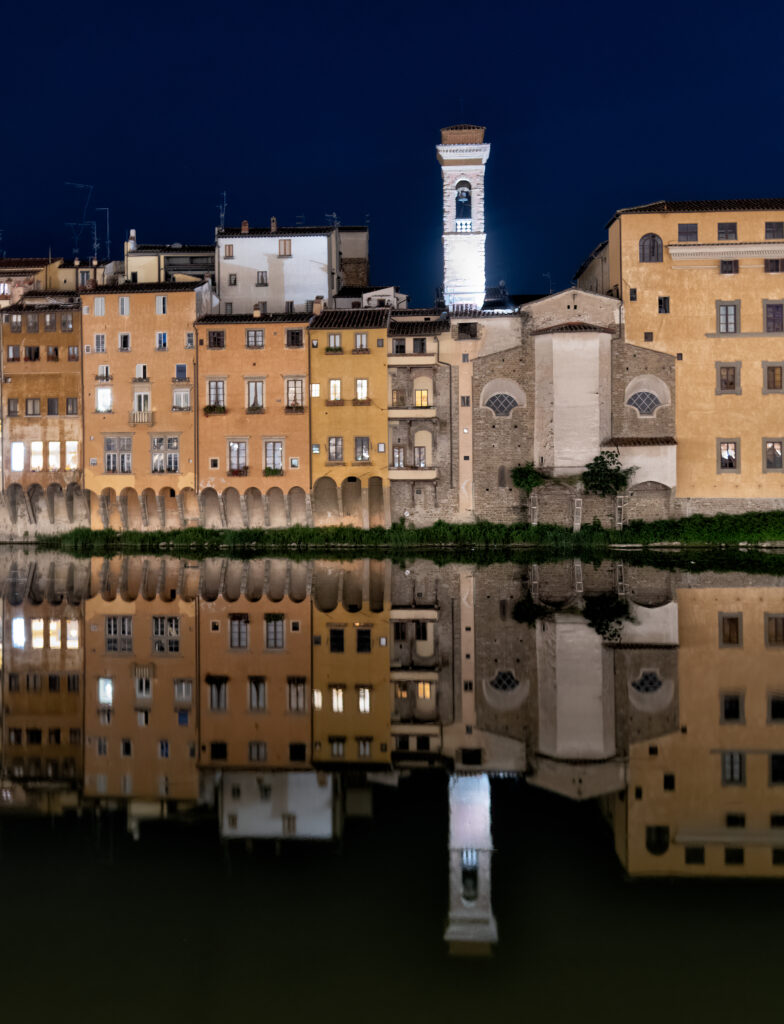 Serene Nighttime Wallpaper: Illuminated Buildings & Tower Reflection