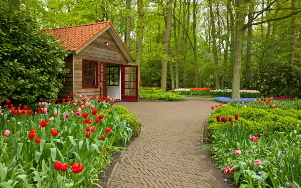 Enchanting House amidst Vibrant Gardens - a Breathtaking HD Wallpaper