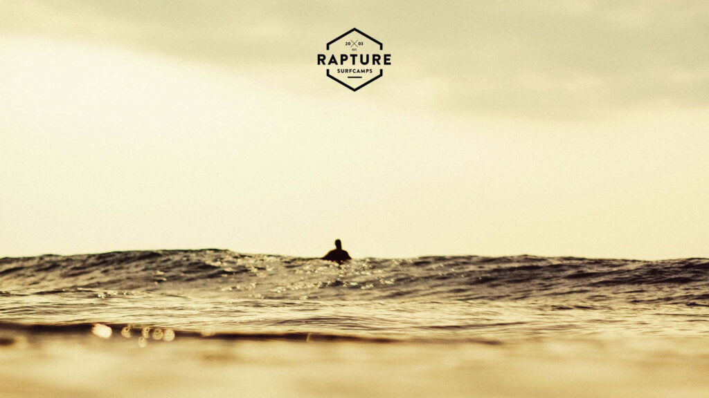 Serene Ocean Sunset Wallpaper: Calming Surfer Scene Background