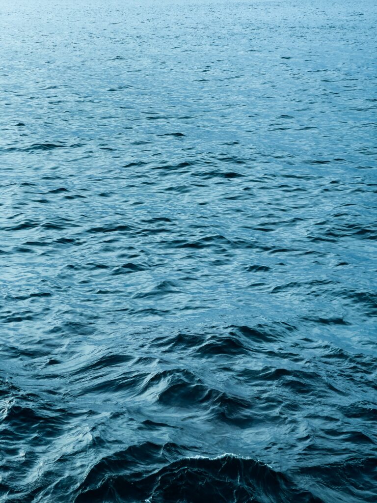 Serene ocean wallpaper with gentle rolling deep blue waves for calming desktop background