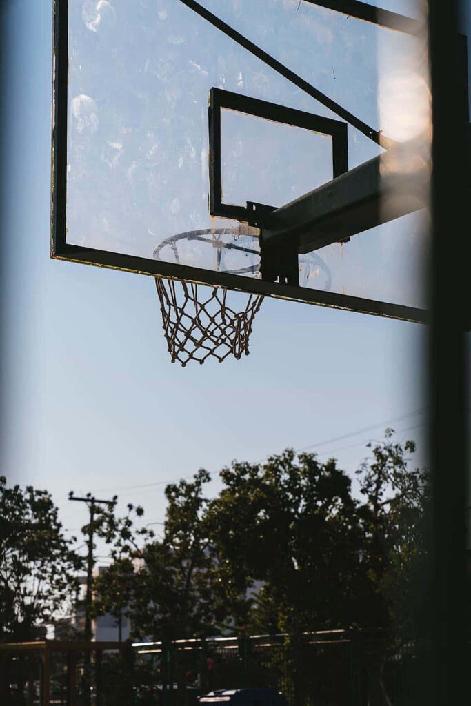 Serene Outdoor Basketball Hoop Silhouette: Peaceful Wallpaper Background