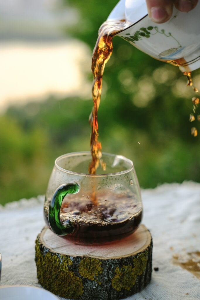 Serene Tea Pour: Refreshing Outdoor Wallpaper with Glass Mug
