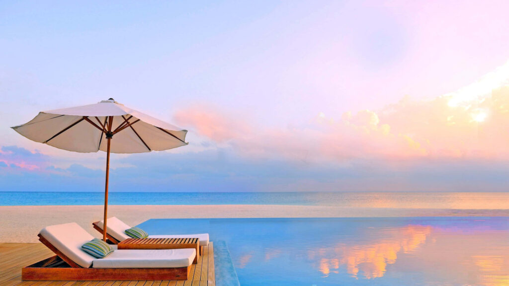 Tranquil Paradise Beach Wallpaper: Sunset, Lounge Chairs & Infinity Pool
