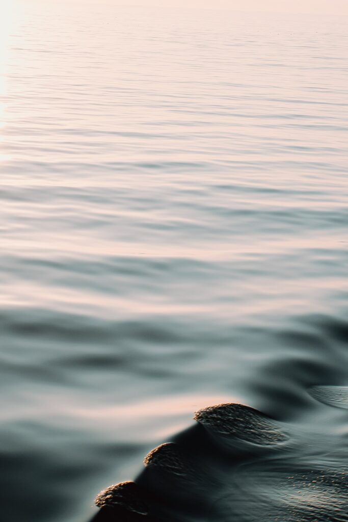 Serene wallpaper with gentle waves and pastel ripples on smooth water creating calm minimalist background