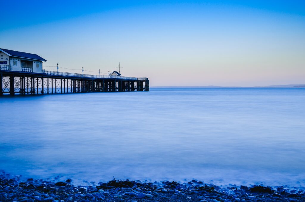 Tranquil Penarth Pier Wales with soft blue hues reflecting calm sea and sky minimalist wallpaper
