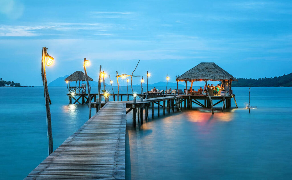 Serene Pier at Dusk: Tranquil Waters & Cozy Wooden Dock Background Wallpaper