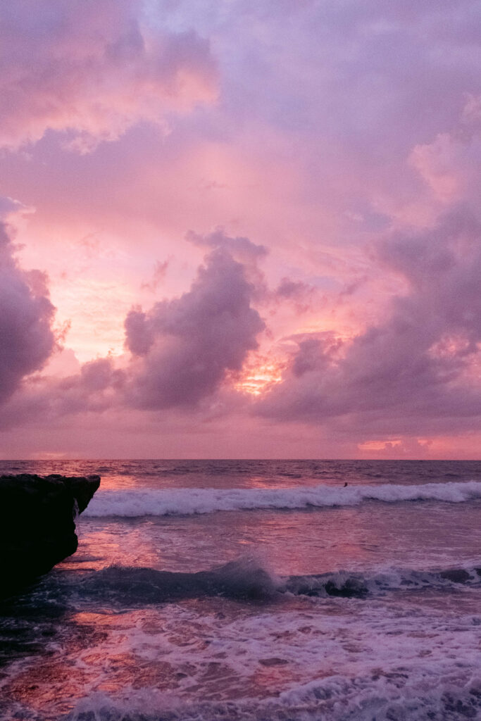 Serene Pink Beach Sunset Wallpaper: Calming Seaside Background