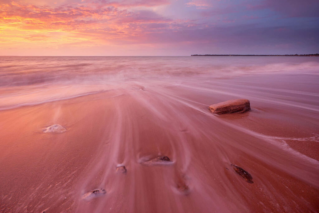 Tranquil Sunset at a Pink Sand Beach: Vibrant Sky & Gentle Waves Wallpaper