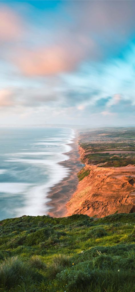 Point Reyes National Seashore cliffs with lush greenery golden rocks and silky long-exposure sea view Wallpaper