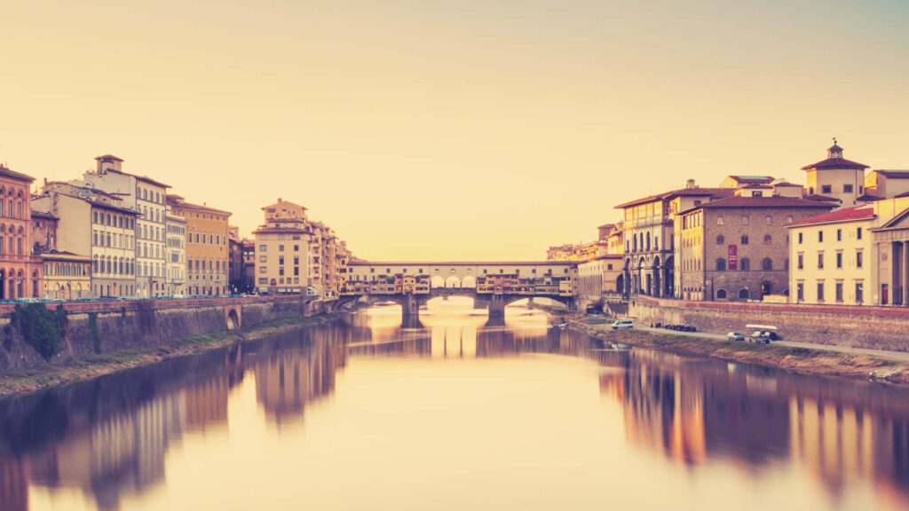 Stunning Ponte Vecchio Wallpaper: Serene Sunset Reflection in Florence
