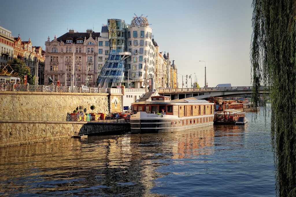 Serene Prague Riverside Wallpaper: Historic Architecture & Modern Design