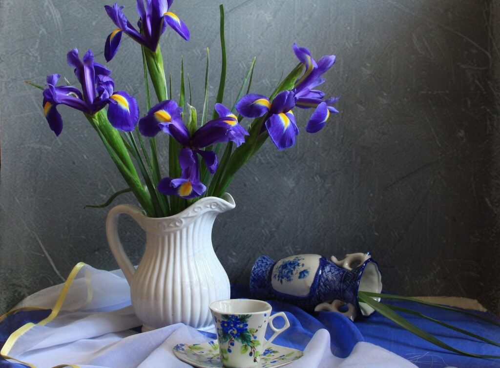 Serene Purple Irises in White Jug - Elegant Still Life Wallpaper