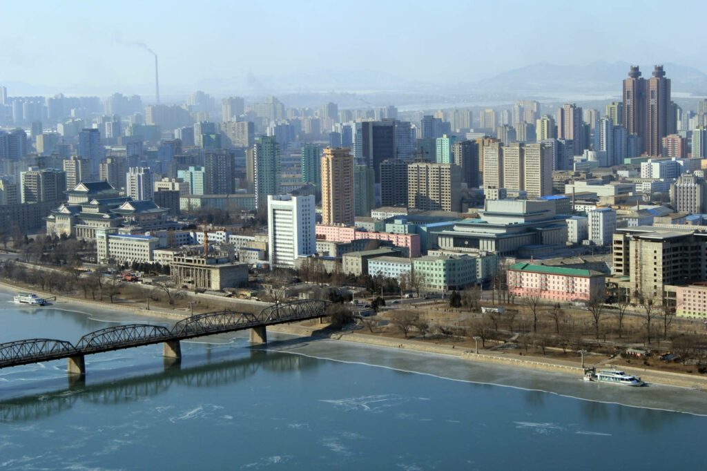 Serene Pyongyang Cityscape with Taedong Bridge - Tranquil Wallpaper