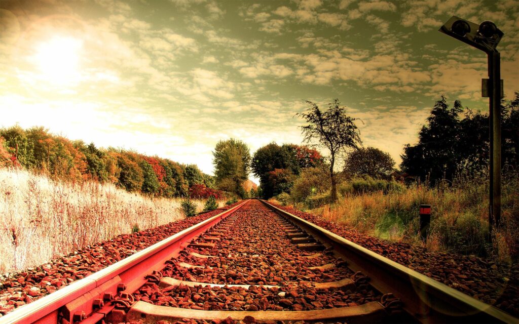 Serene Railroad Wallpaper: Lush Greenery & Picturesque Sky