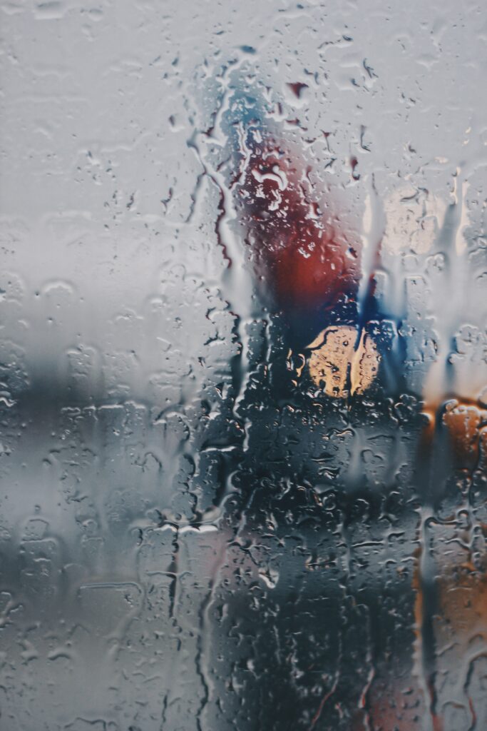 Serene Rain-Covered Glass Wallpaper | Blurred Water Droplets