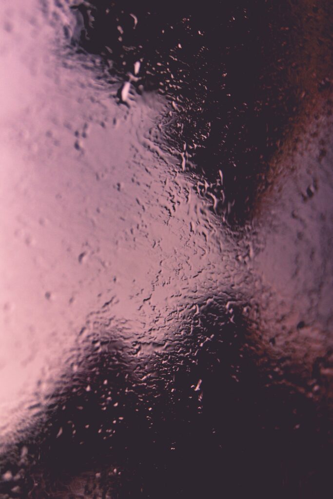 Calming Rain-Covered Glass Wallpaper Background With Delicate Drops