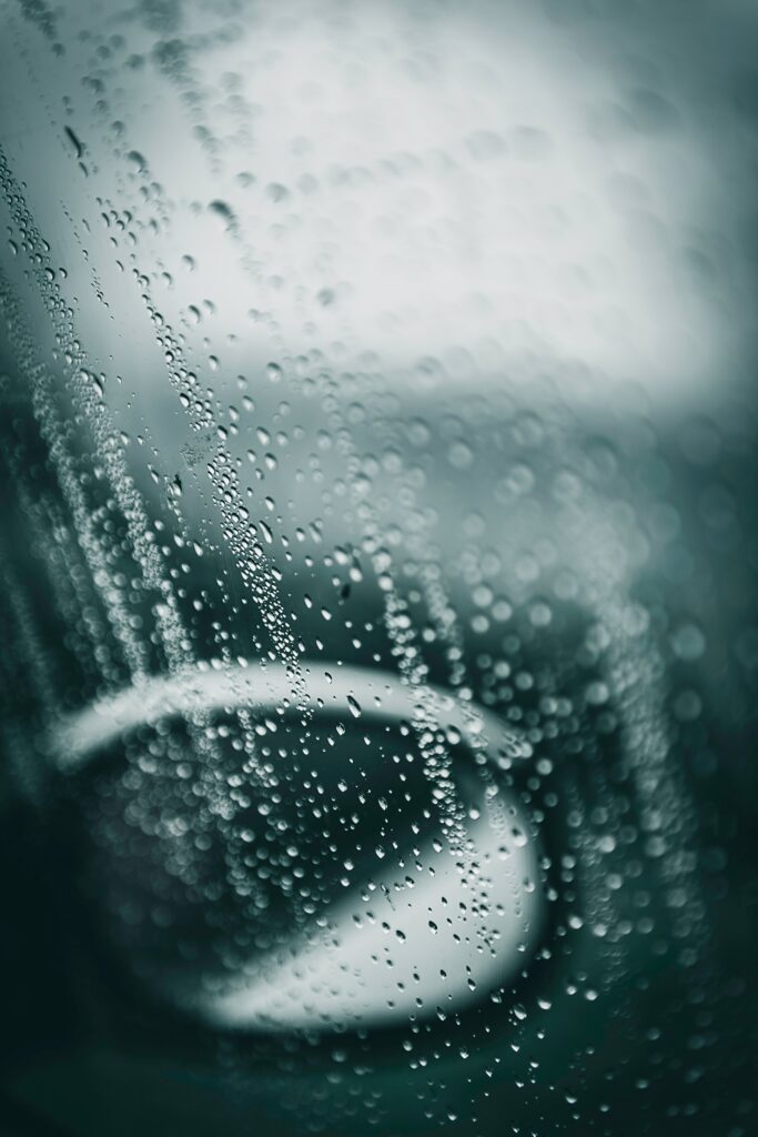 Serene Rain Droplets on Glass: Close-Up Wallpaper Background