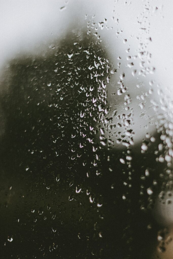 Serene Raindrops on Glass: Moody Wallpaper Background