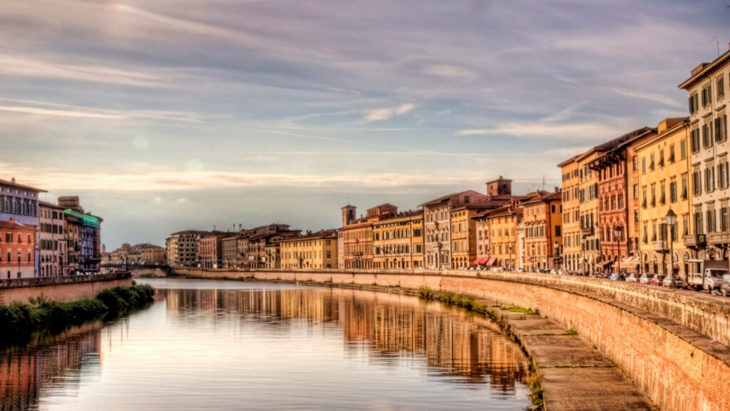 Serene River Arno View in Pisa: Colorful Historic Buildings Wallpaper