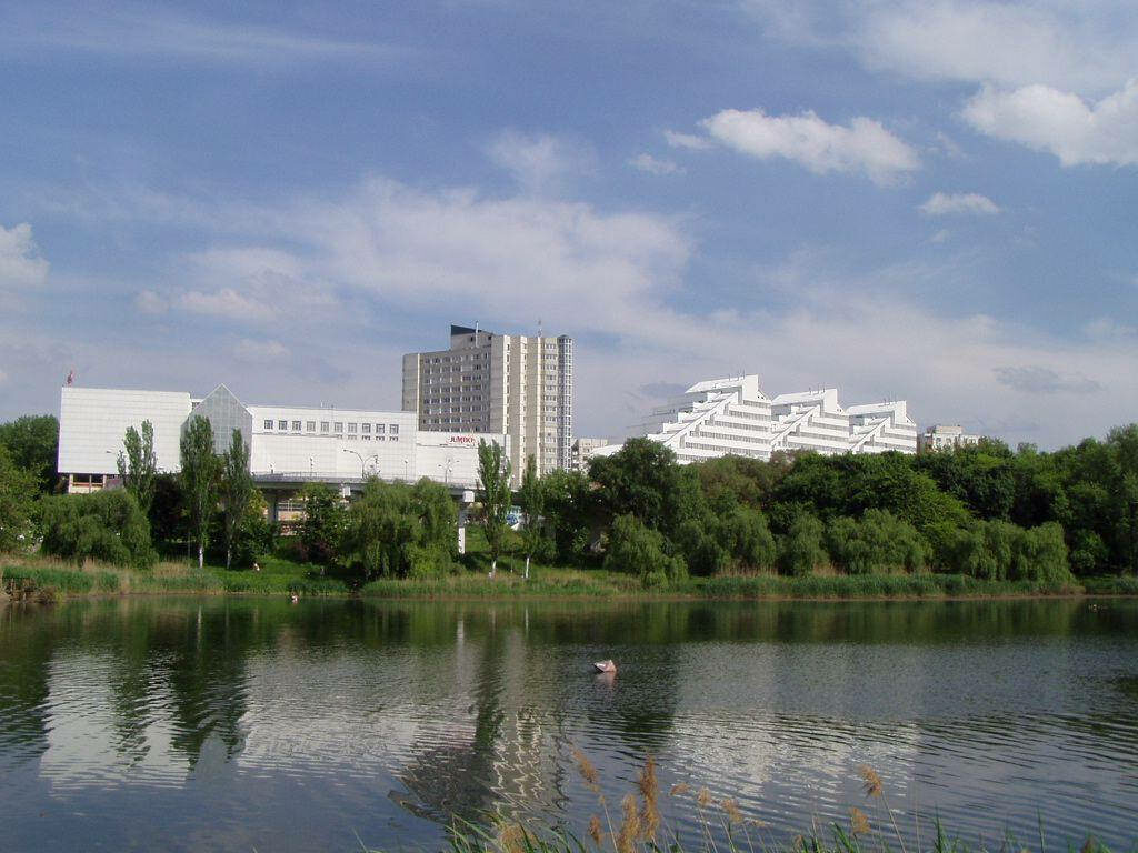 Serene River View Wallpaper with Unique Moldovan Buildings