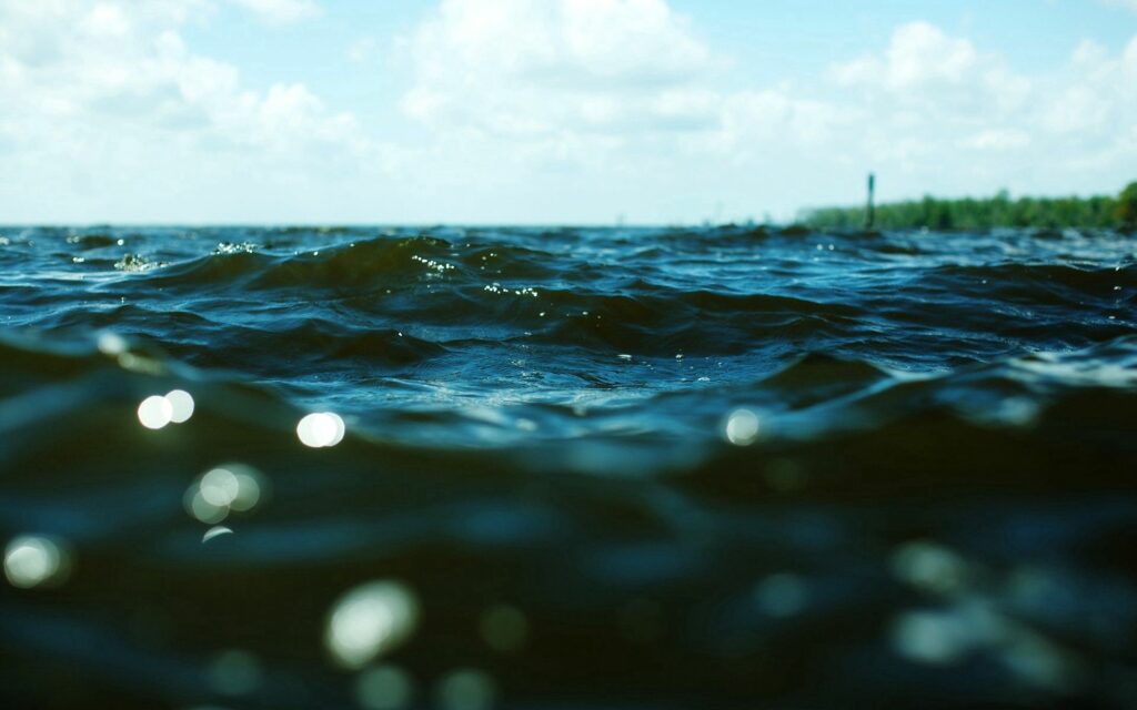 River surface wallpaper with detailed sunlight ripples deep blue green natural refreshing scene