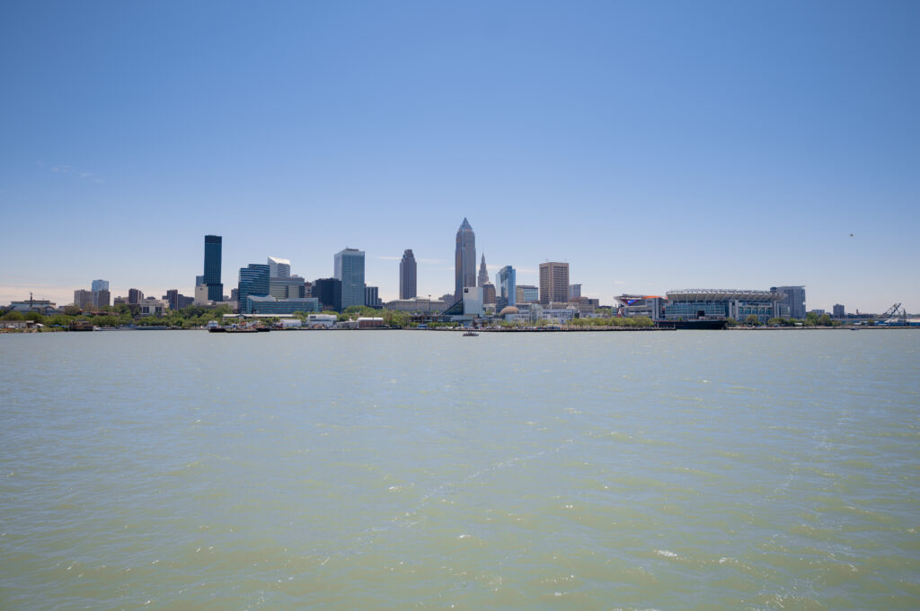 Tranquil Riverscape Wallpaper: City Skyline & Blue Sky Beauty