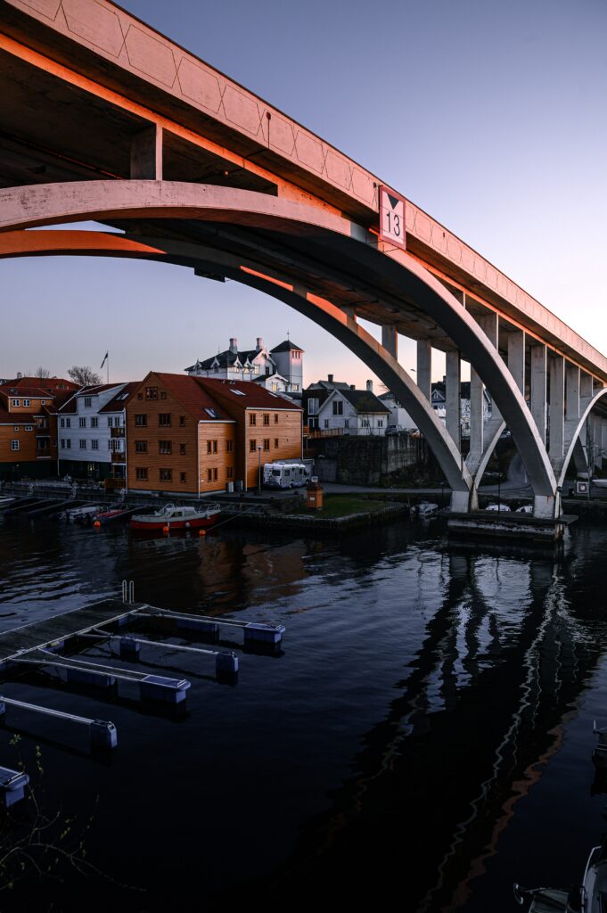 Serene Cityscape Wallpaper: Charming Riverside View & Arched Bridge