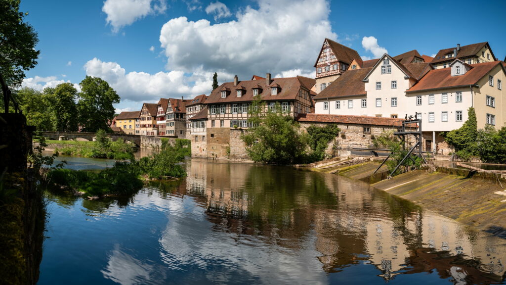 Riverside Serenity: A Quaint Town Reflected in Baden-Württemberg's Waters Wallpaper