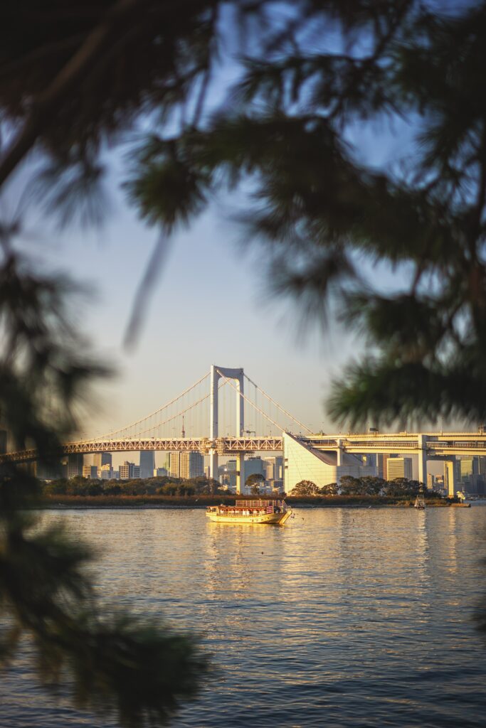 Serene Riverside Wallpaper with Bridge and Boat – Peaceful Background