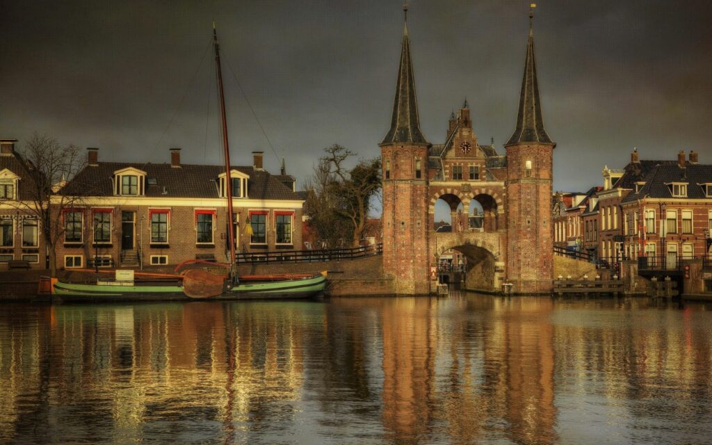 Serene Riverside Wallpaper: Historic Bridge & Charming Houses