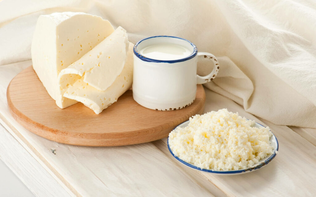 Wholesome Rustic Wallpaper: Milk & Cheese on Wooden Table Background