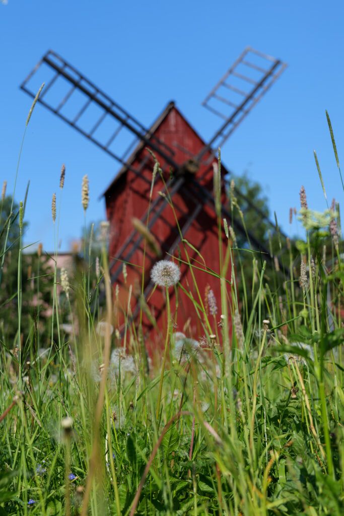 Picturesque Red Windmill Wallpaper: Rustic Countryside Background