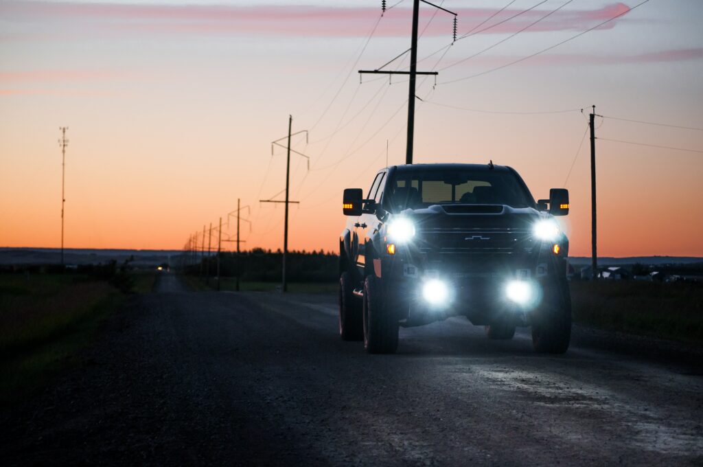 Serene SUV Journey on Rural Road at Dusk with Sunset Background Wallpaper