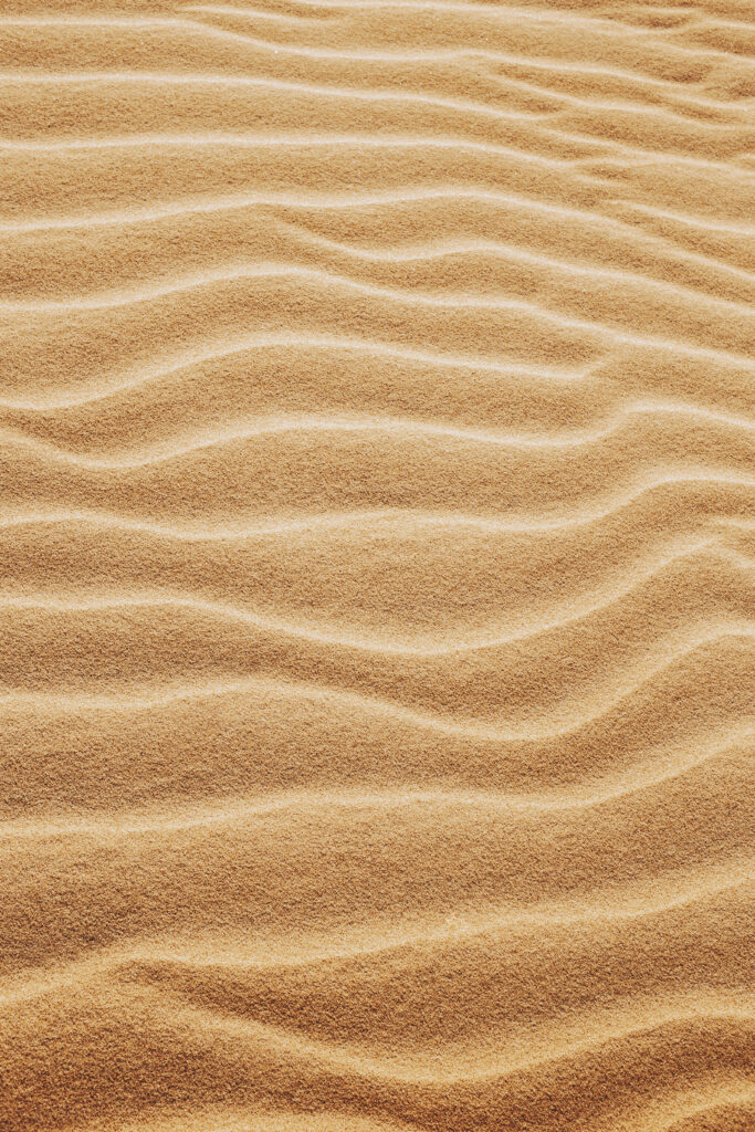 Serene Sandy Beachfront Wallpaper: Calming Nature Background
