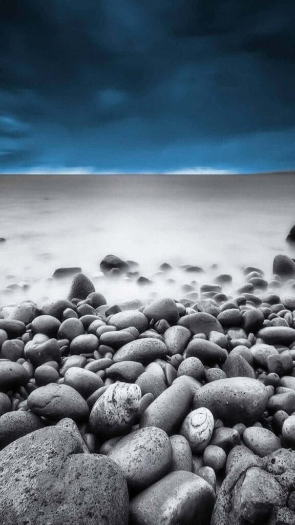 Serene Seascape Wallpaper: Smooth Pebbles & Misty Shoreline