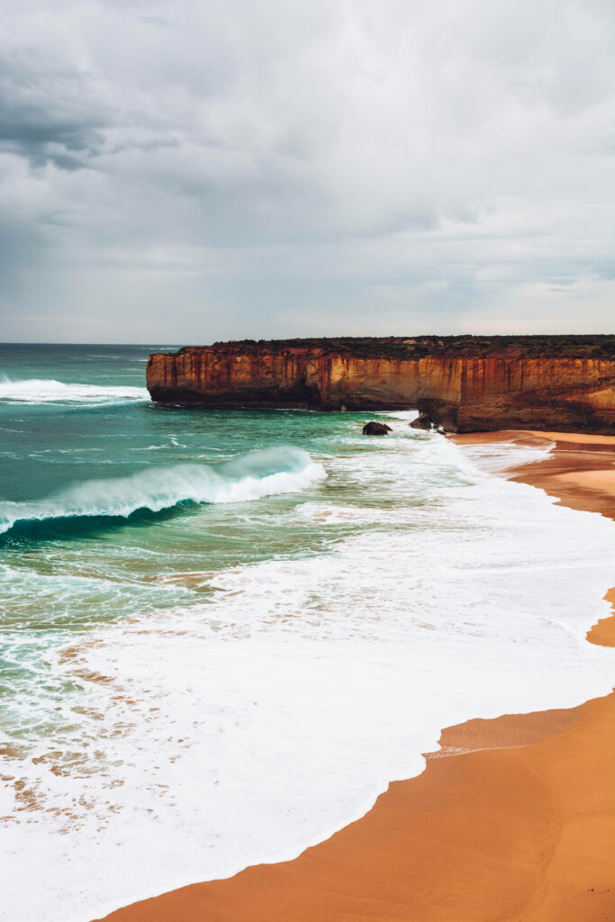 Stunning Seaside Wallpaper: Dramatic Cliffs & Serene Beach Background