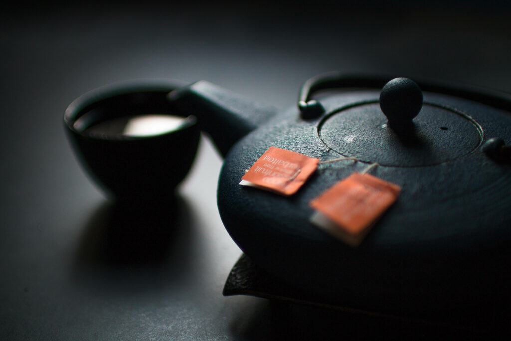 Captivating Tea Ceremony Still Life: Authentic Japanese Black Kettle and Teacups in Atmospheric Kitchen Setting Wallpaper