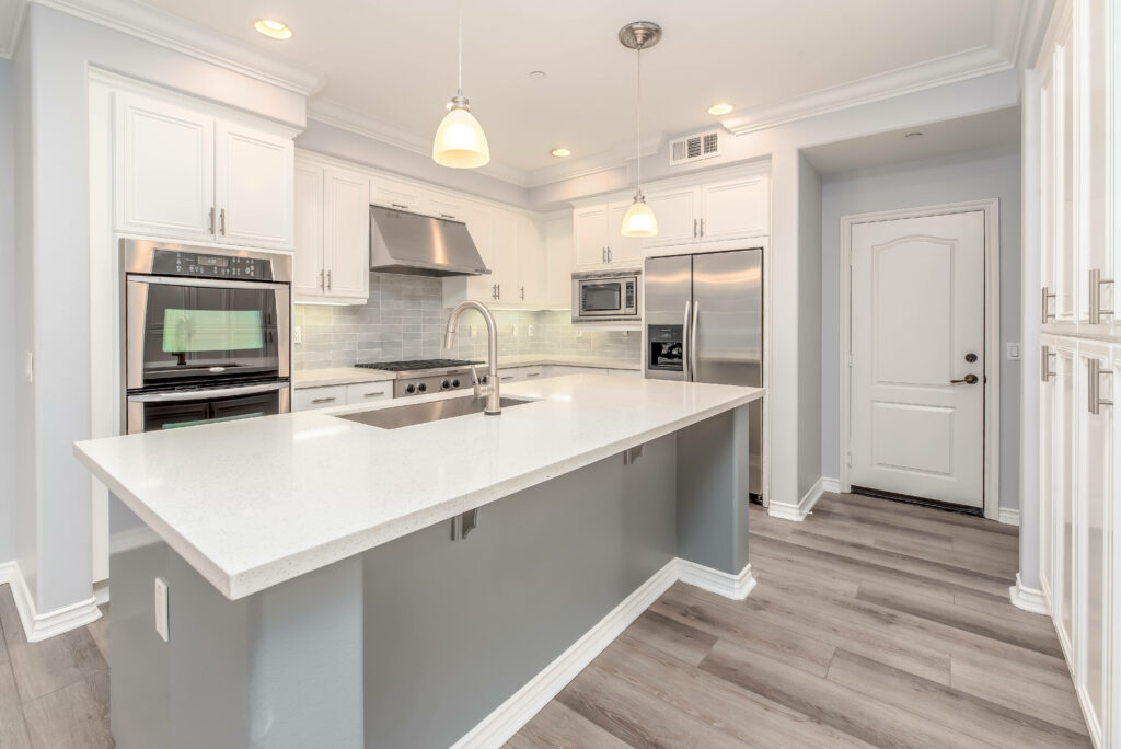 Simplicity in Style: A Captivating White-Grey Kitchen Interior with Cooking Perfection Wallpaper