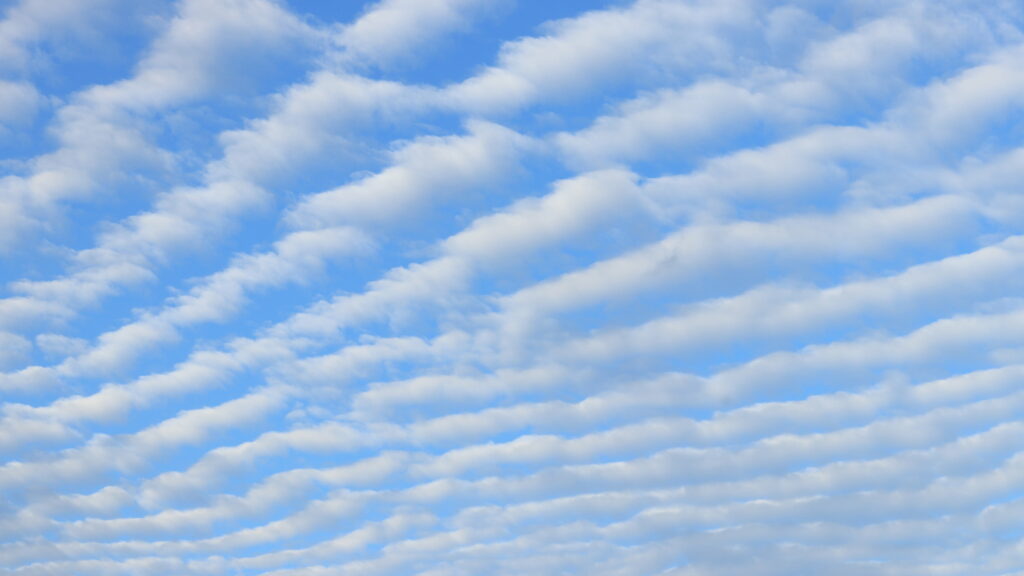 Serene Light Blue Sky HD Wallpaper with Calming Cloud Patches