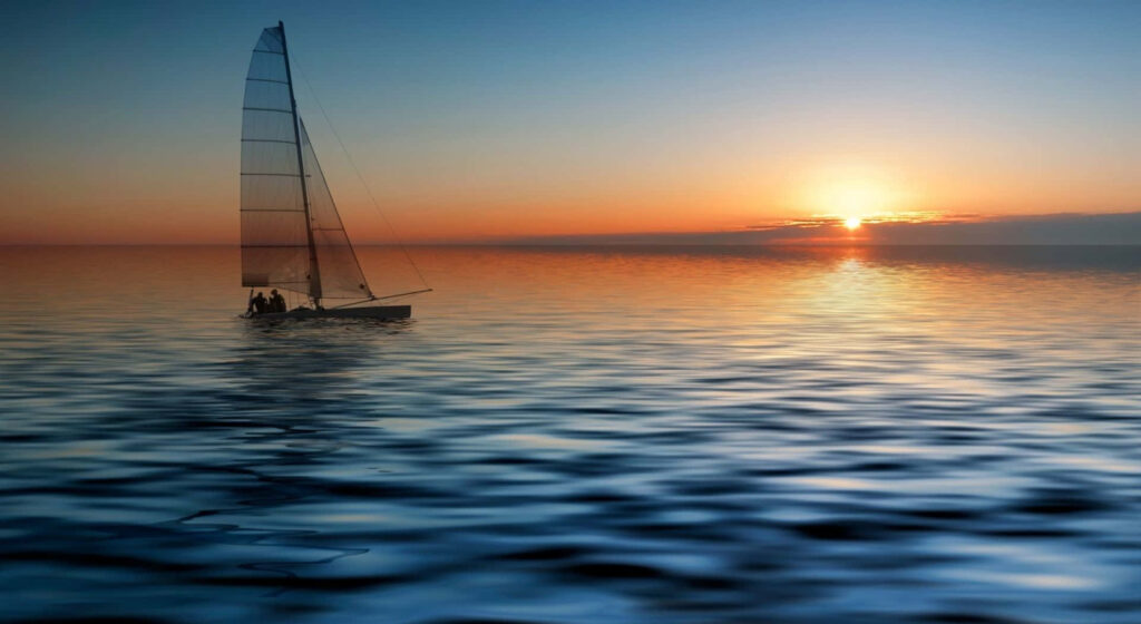 Small sailboat gliding on calm water at sunset peaceful boat ride wallpaper background