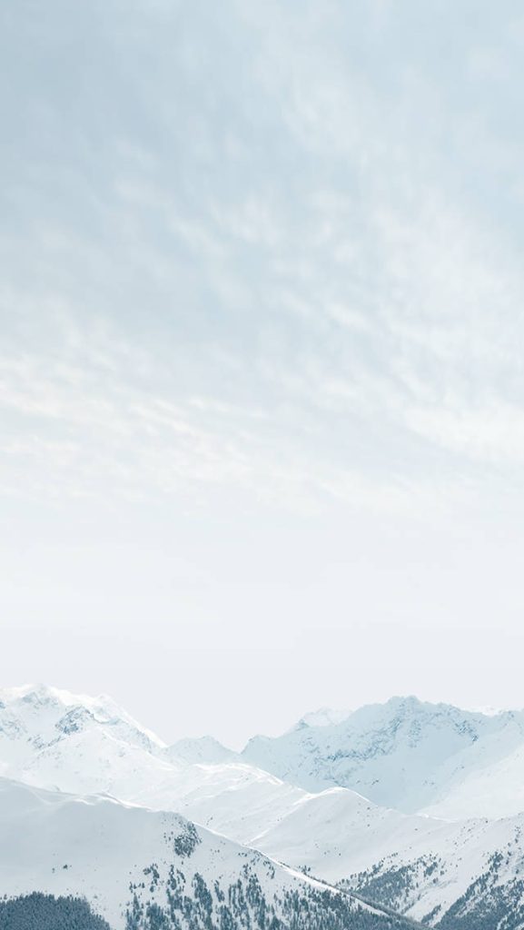 iOS 6 wallpaper with snow-covered mountains and pale blue sky minimalist serene background