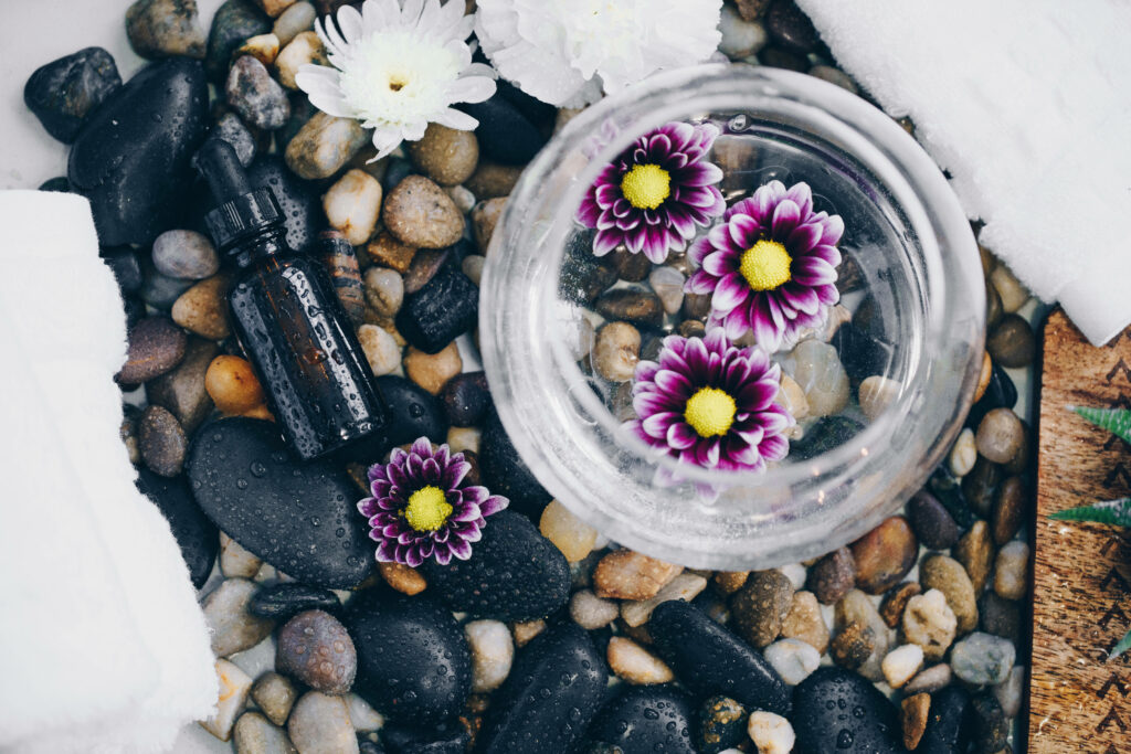 Serene Spa Wallpaper: River Stones & Purple Flowers for Relaxing Decor
