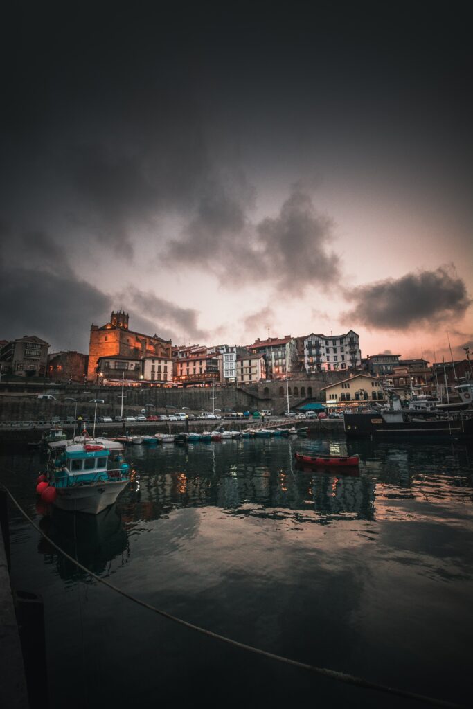 Enchanting Spanish Fishing Town Wallpaper: Calm Waters & Historic Charm