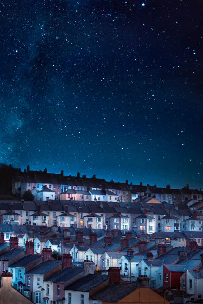 Charming Building Wallpaper: Serene Starry Night Sky Background
