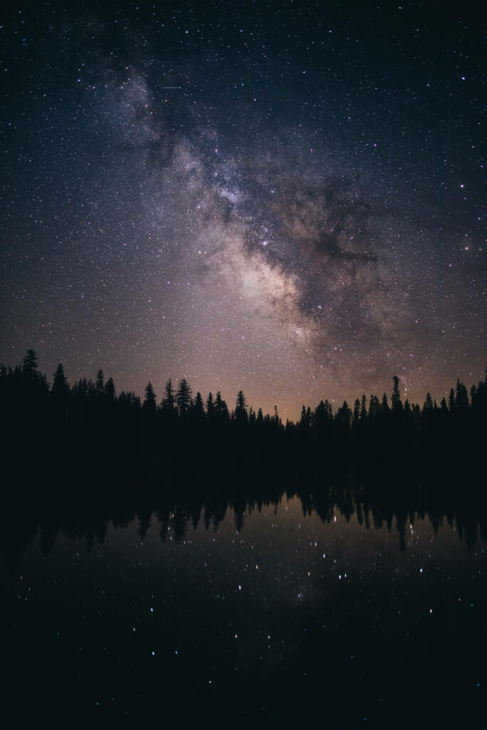 Serene Starry Night Sky Wallpaper Reflecting on Calm Forest Lake