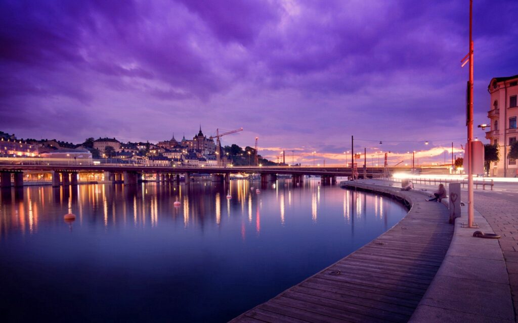 Serene Stockholm Cityscape Wallpaper at Twilight - Vibrant Waterfront Reflection